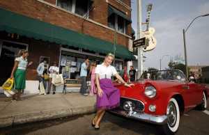 16 Aug 2007, Memphis, Tennessee, USA --- An Elvis fan poses with a convertible in front of Sun Studios in Memphis, where Elvis recorded several of his first songs. --- Image by © Lucas Jackson/Reuters/Corbis