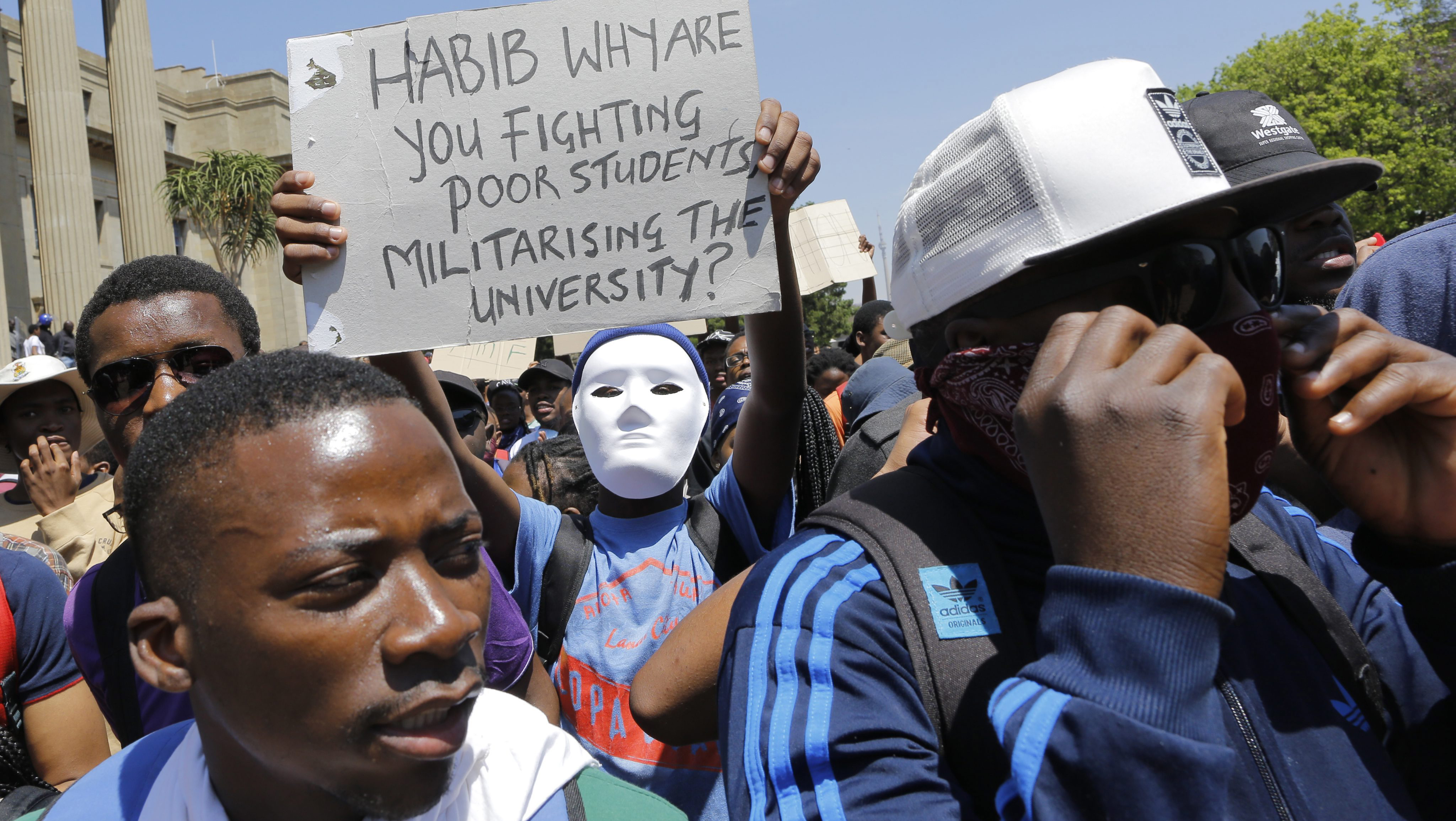 epa05579686 Students from Wits University demonstrate on campus during a fourth week of clashes with police forces during ongoing protests against the cost of higher education in Johannesburg, South Africa, 10 October 2016. The ministry of education announced a 8 percent increase of university fees following calls by student demonstrators of a zero percent increase. The violent protests have spread to many of the countries higher education campuses and have been ongoing for several weeks. EPA/KIM LUDBROOK