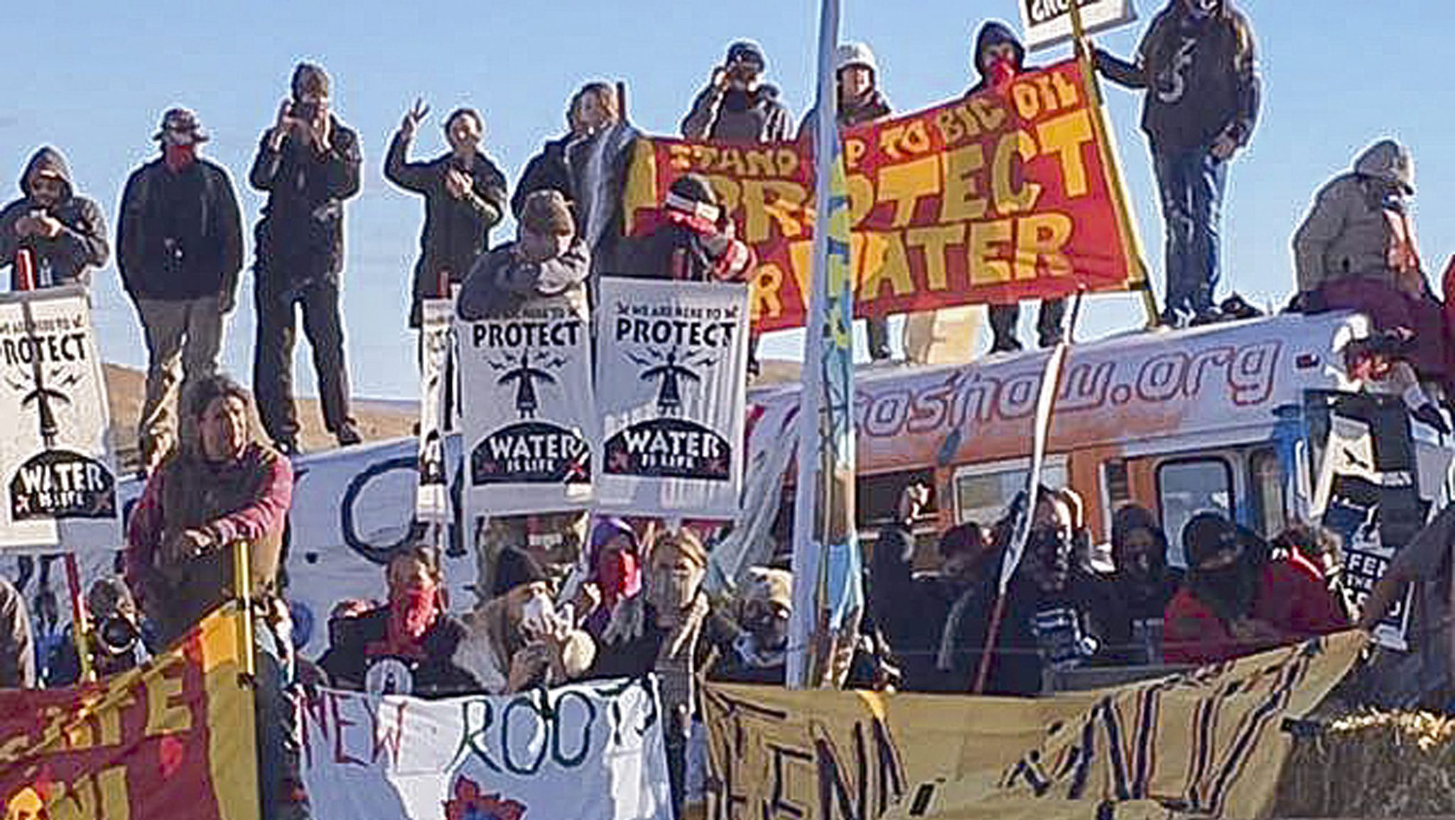 epa05606383 A handout picture made available by the Morton County Sheriff's Department shows protesters holding placards during a demonstration against the North Dakota oil pipeline project, along the Dakota Access Pipeline construction site, in Morton County, North Dakota, USA, 27 October 2016. EPA/MORTON COUNTY SHERIFF'S DEPARTMENT / HANDOUT -- BEST QUALITY AVAILABLE -- HANDOUT EDITORIAL USE ONLY/NO SALES