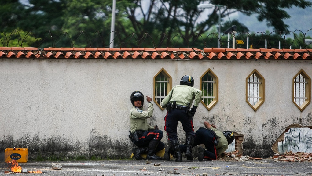 Demonstrators clash with a group of unidentified civilians in a street in Caracas