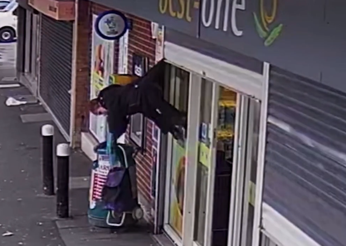 Woman found hanging upside down in the air after her coat got stuck in store roll – watch viral video